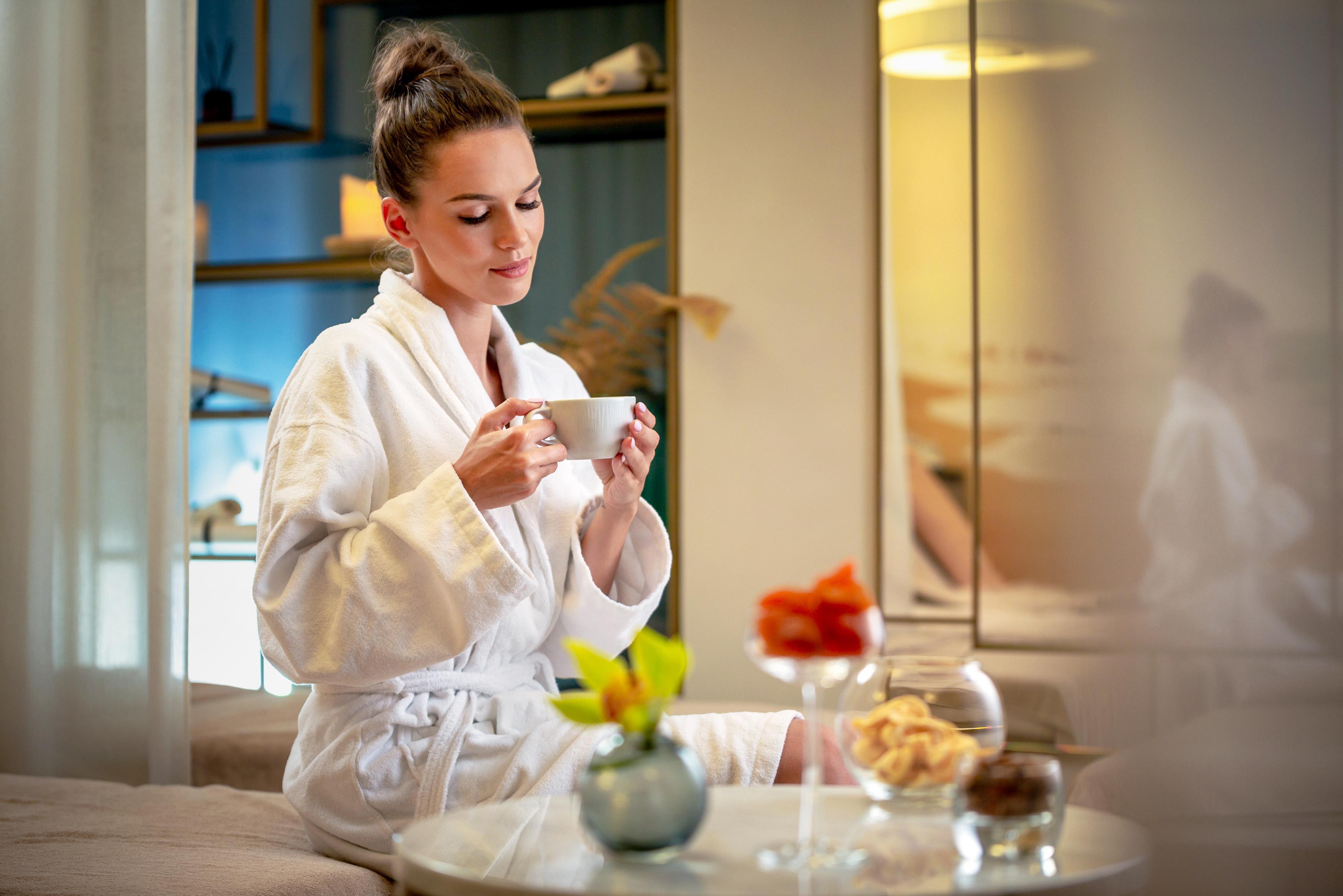 Grand Poet Hotel And Spa By Semarah Riga Ngoại thất bức ảnh A woman wearing a bathrobe