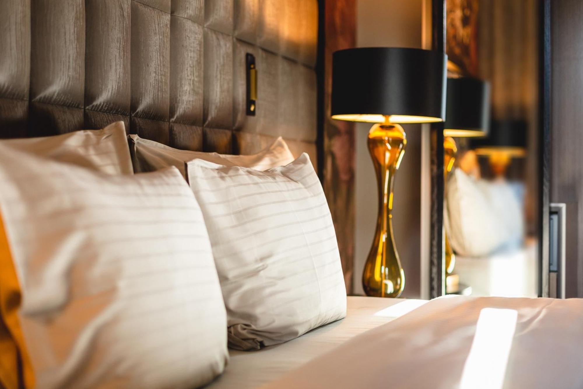 Grand Poet Hotel And Spa By Semarah Riga Ngoại thất bức ảnh A bed with pillows